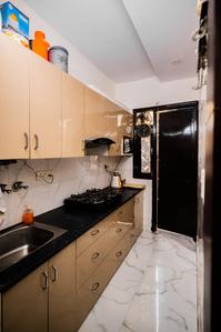 Kitchen Image of Neeru Raman PG in Janakpuri, New Delhi