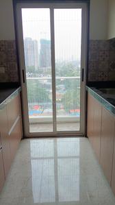 Kitchen Image of 710 Sq.ft 1 BHK Apartment / Flat for sale in Anand Saket World, Kalyan East Kalyan for Rs. 5500000