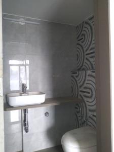 Common Bathroom Image of 420 Sq.ft 1 BHK Apartment / Flat for sale in Divine Sky Aura Building No 2, Mulgaon Vasai for Rs. 4400000